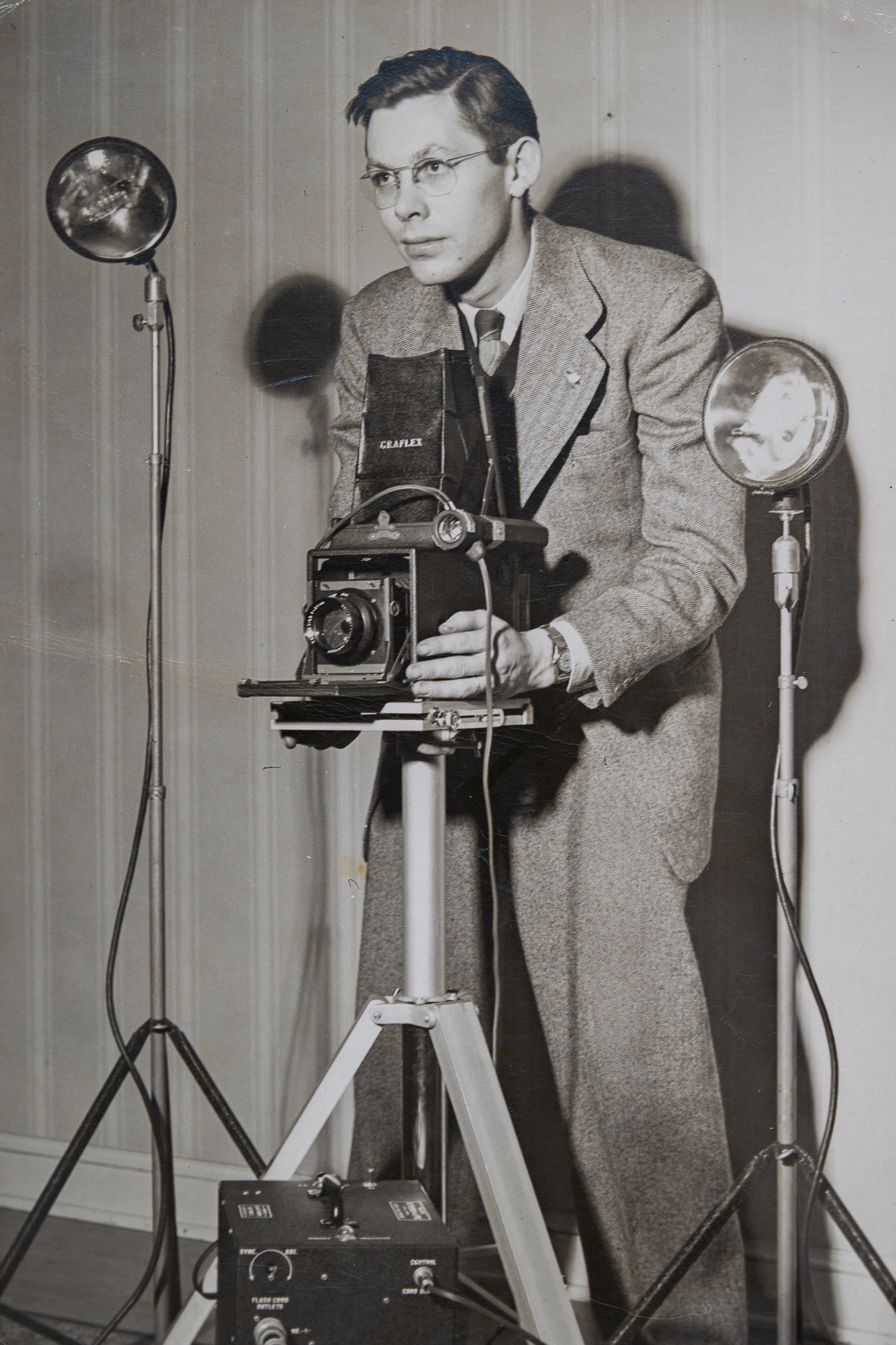 John Hanline standing behind a camera in the 1950s