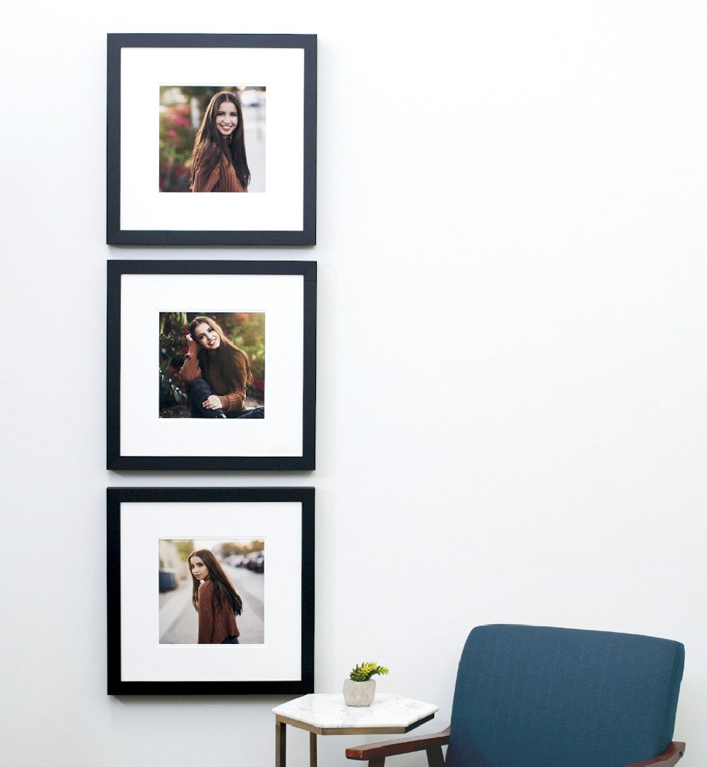 Three senior portrait Gallery Framed Prints hung vertically by blue chair