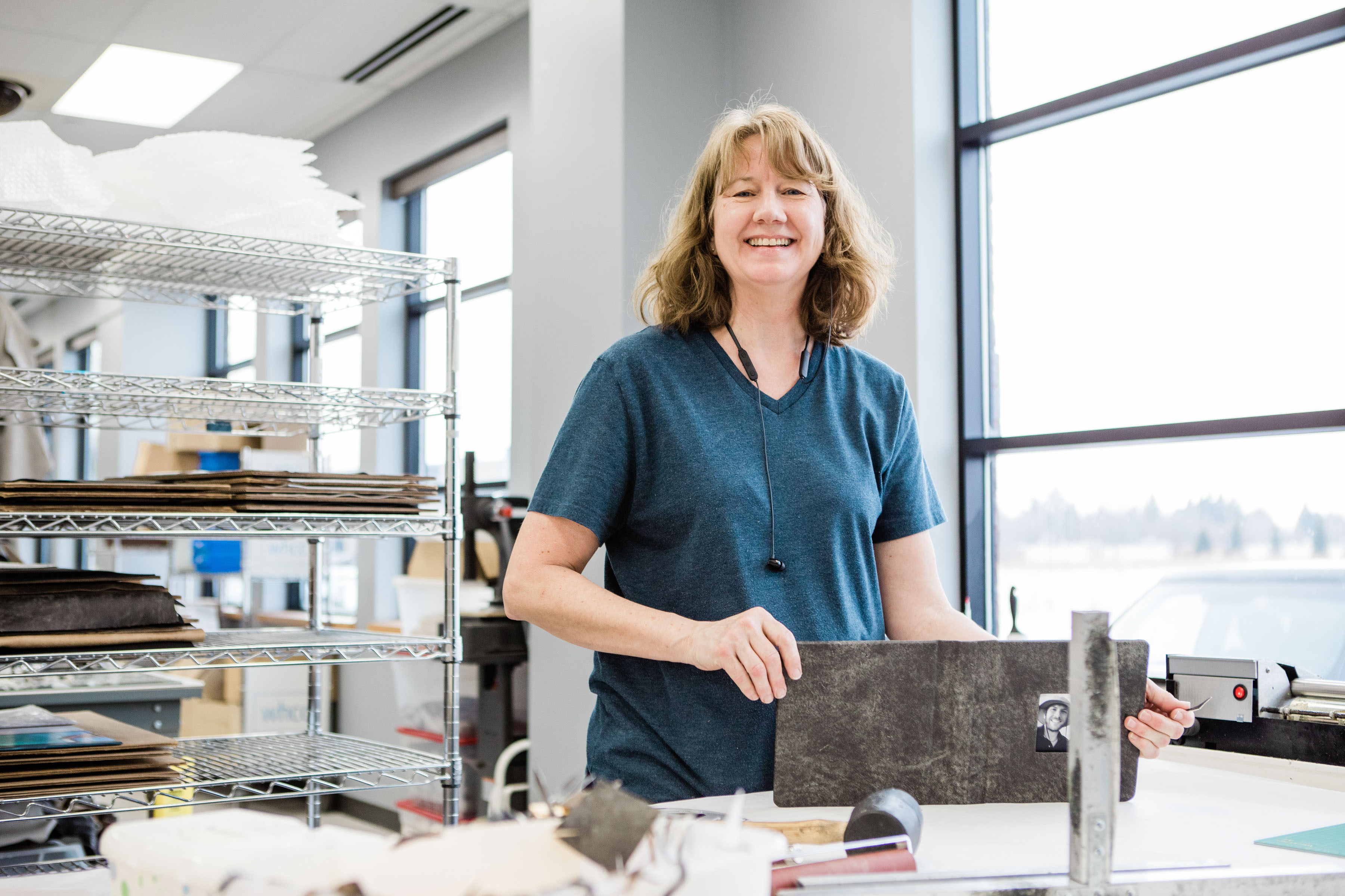 a person showing the craftsmanship in assembling a real leather wedding album cover