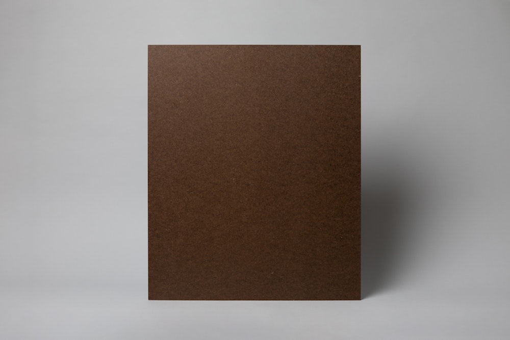 Back of Masonite mounted Portrait Canvas print standing up on a gray background