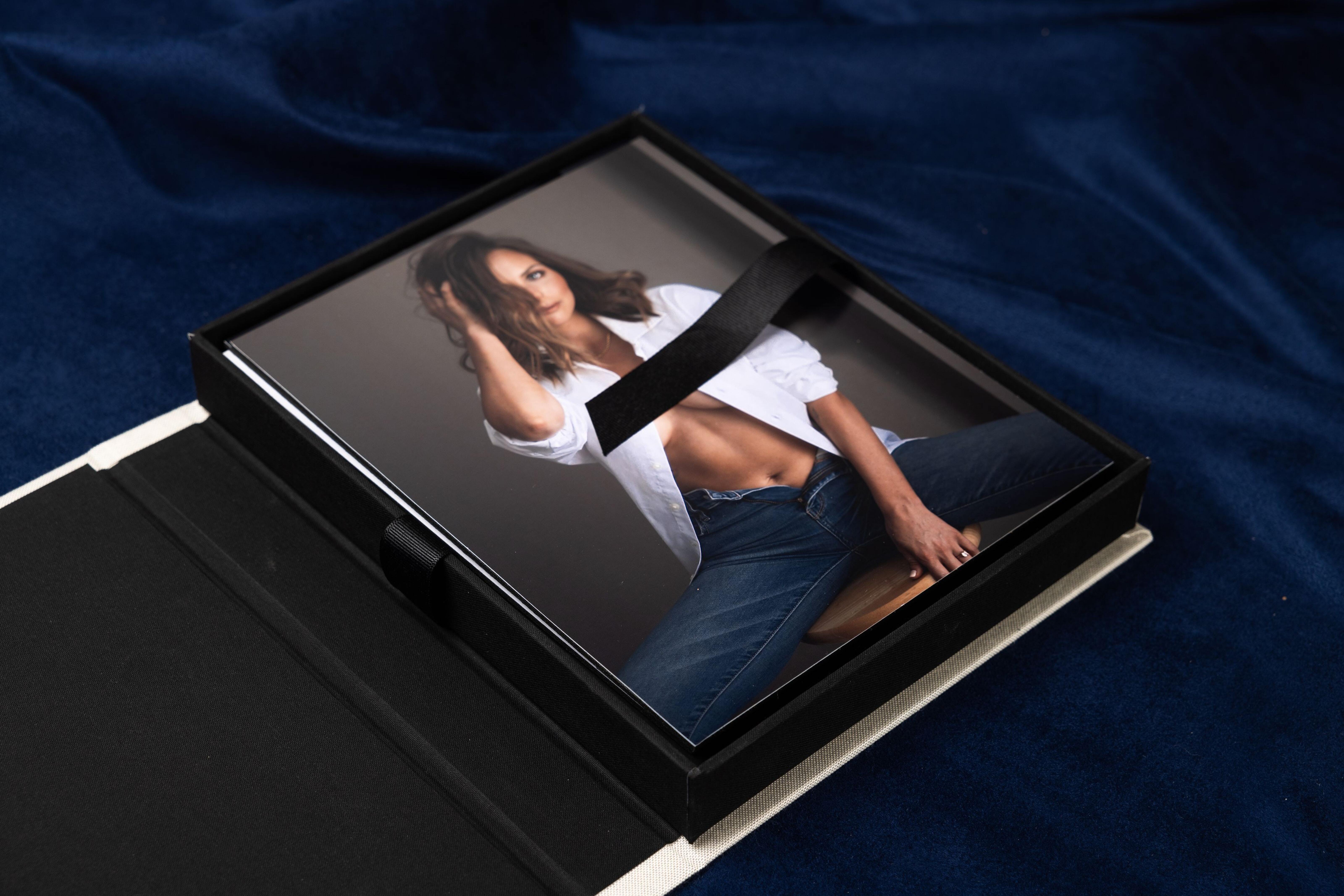 Open boudoir Print Box on navy fabric with a mounted print inside