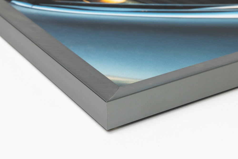 Close-up corner of a Graphite Metal Framed Print moulding on a white background