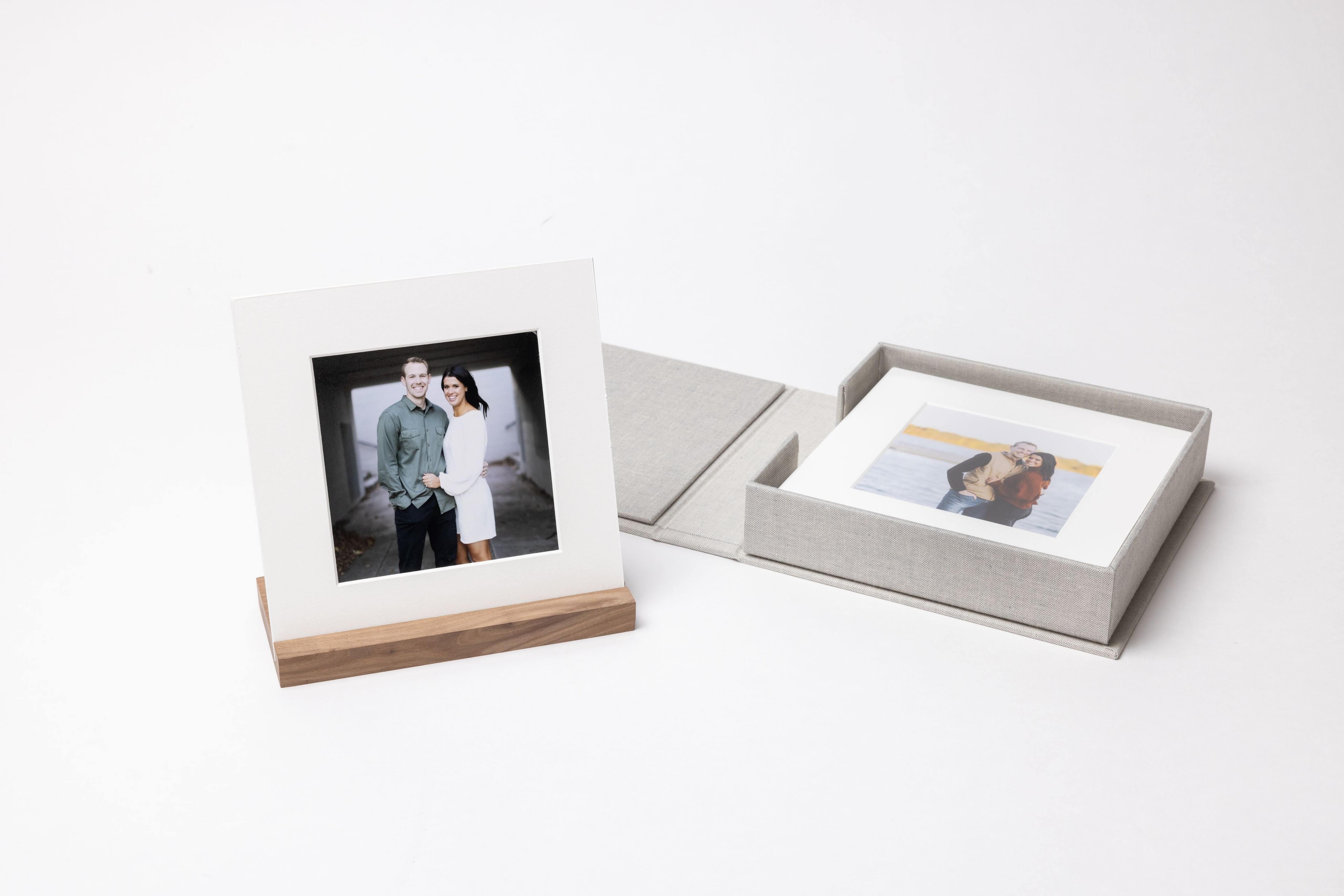 Print Box holding matted engagement prints, with a matted print displayed on a wood stand