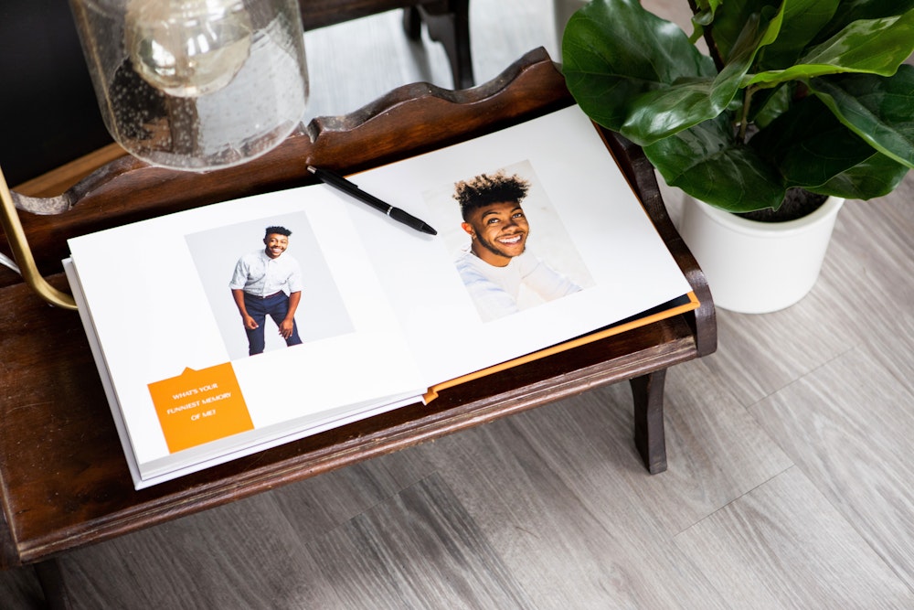 Senior graduation photo sign in Layflat Book on table with pen