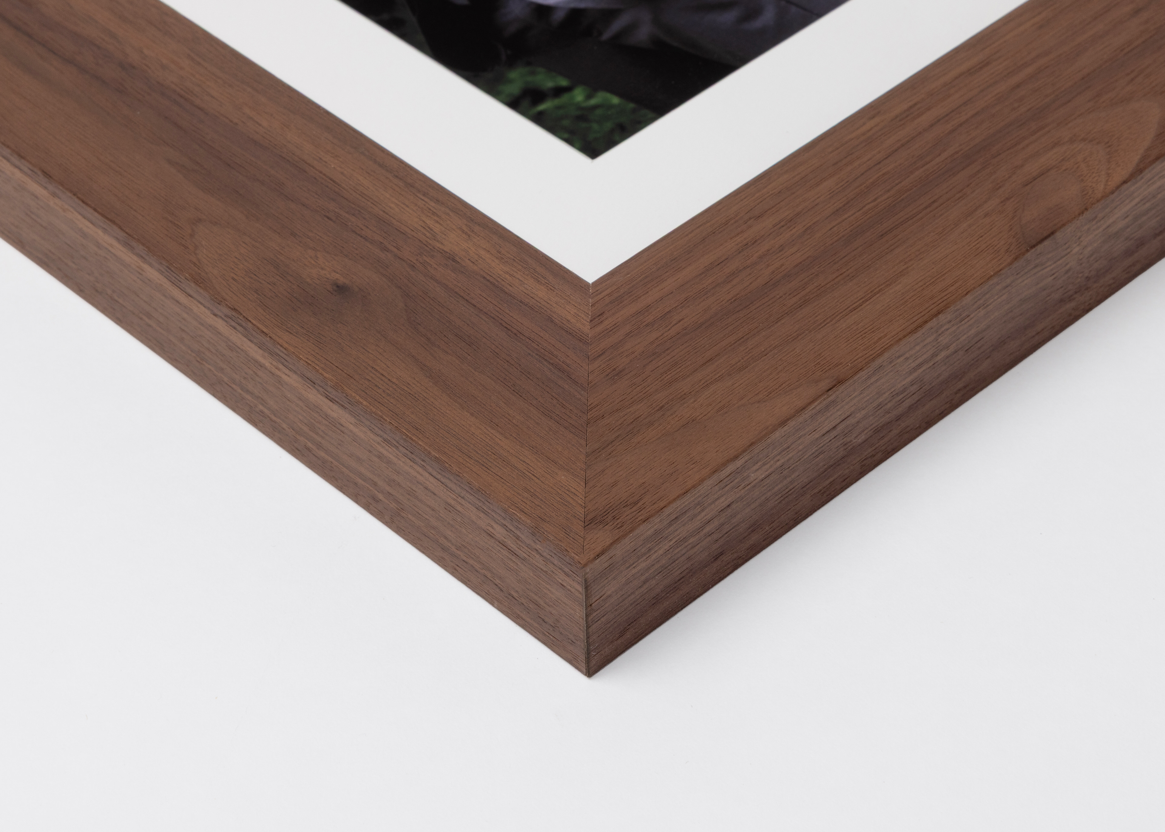 Corner detail of walnut Woodland Frame moulding in 2¼" width