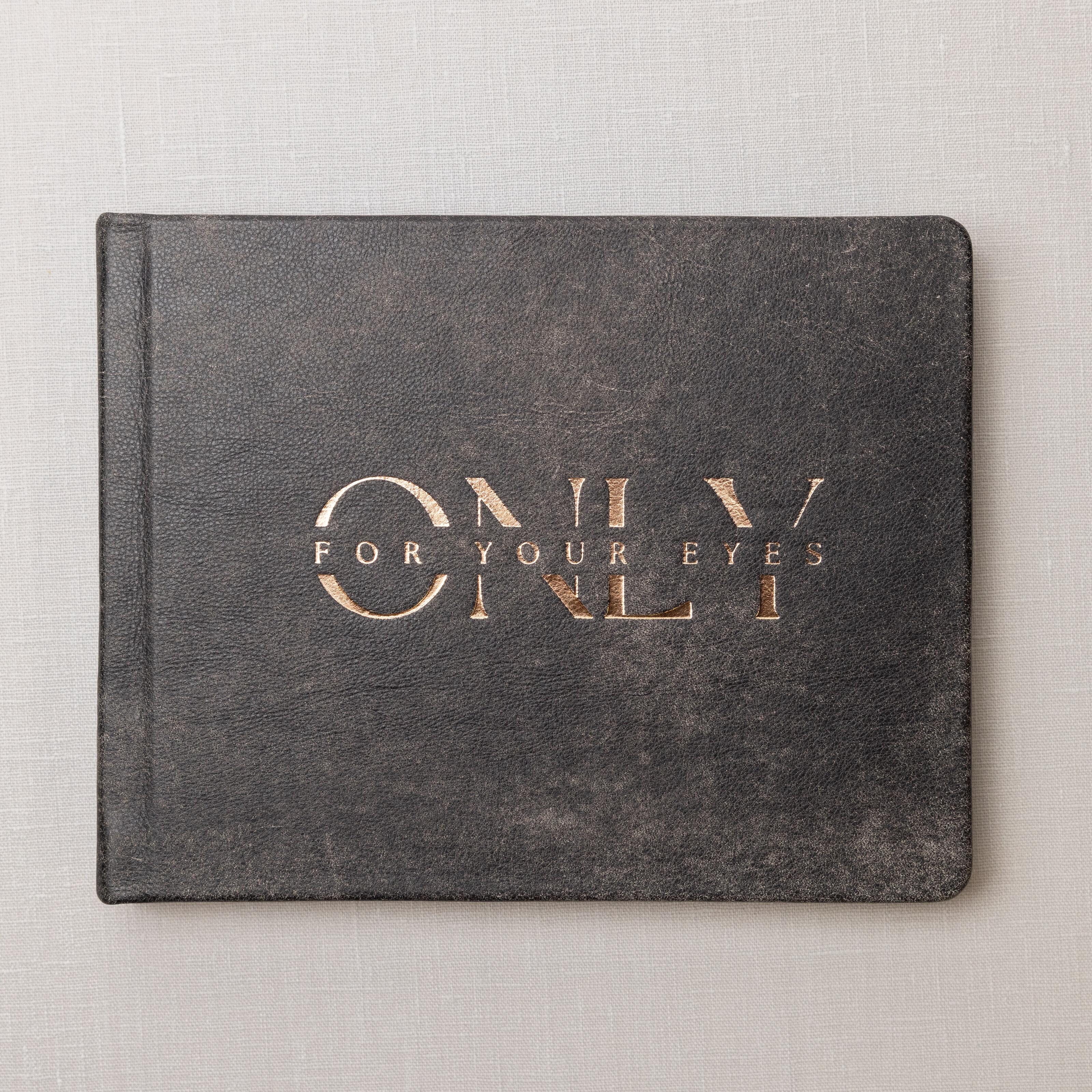 Distressed Black Leather Album cover with rose gold foil custom debossing reading "Only For Your Eyes Only".