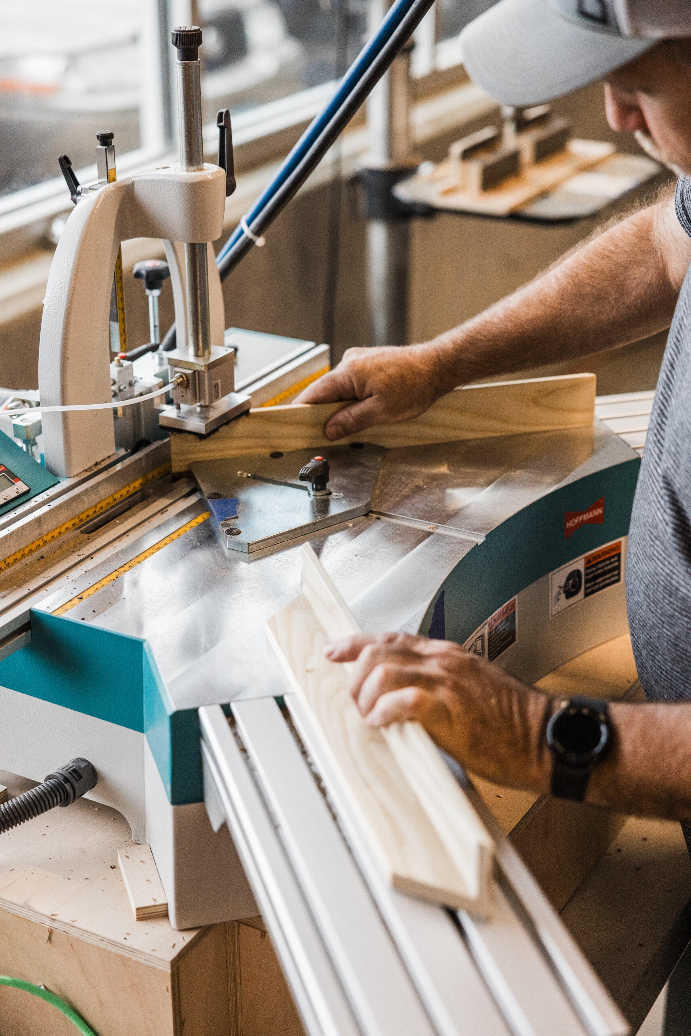 a person assembling and joining frames made from real hardwood