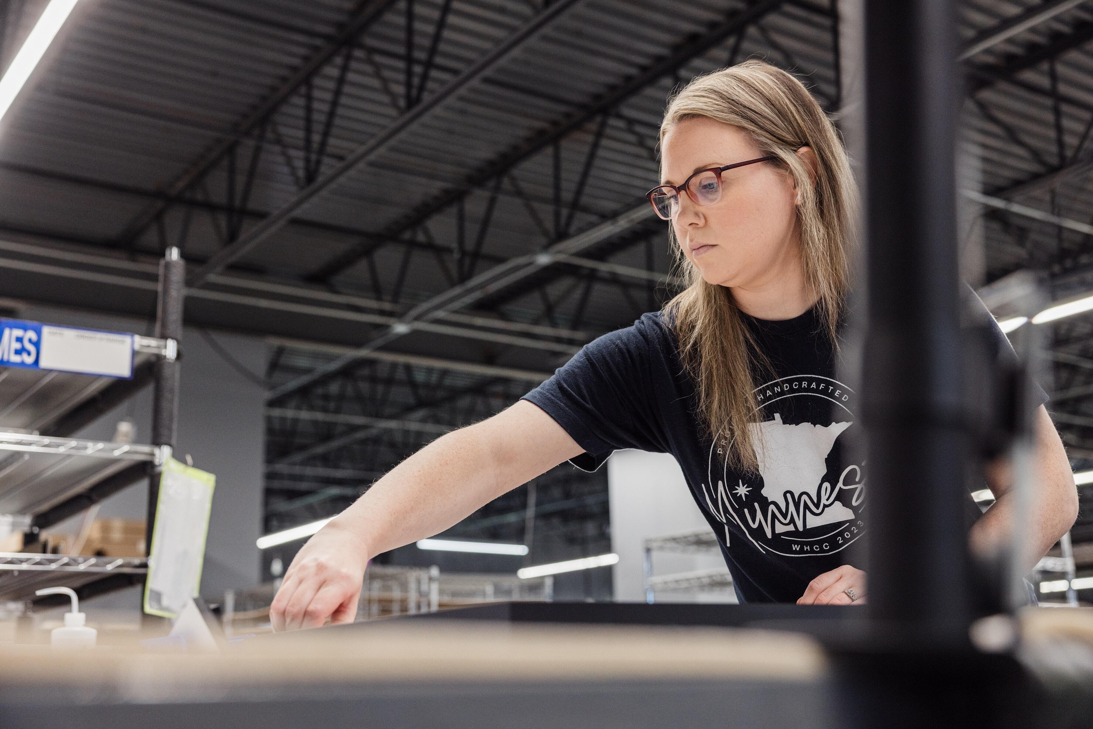 production worker assembling wall art