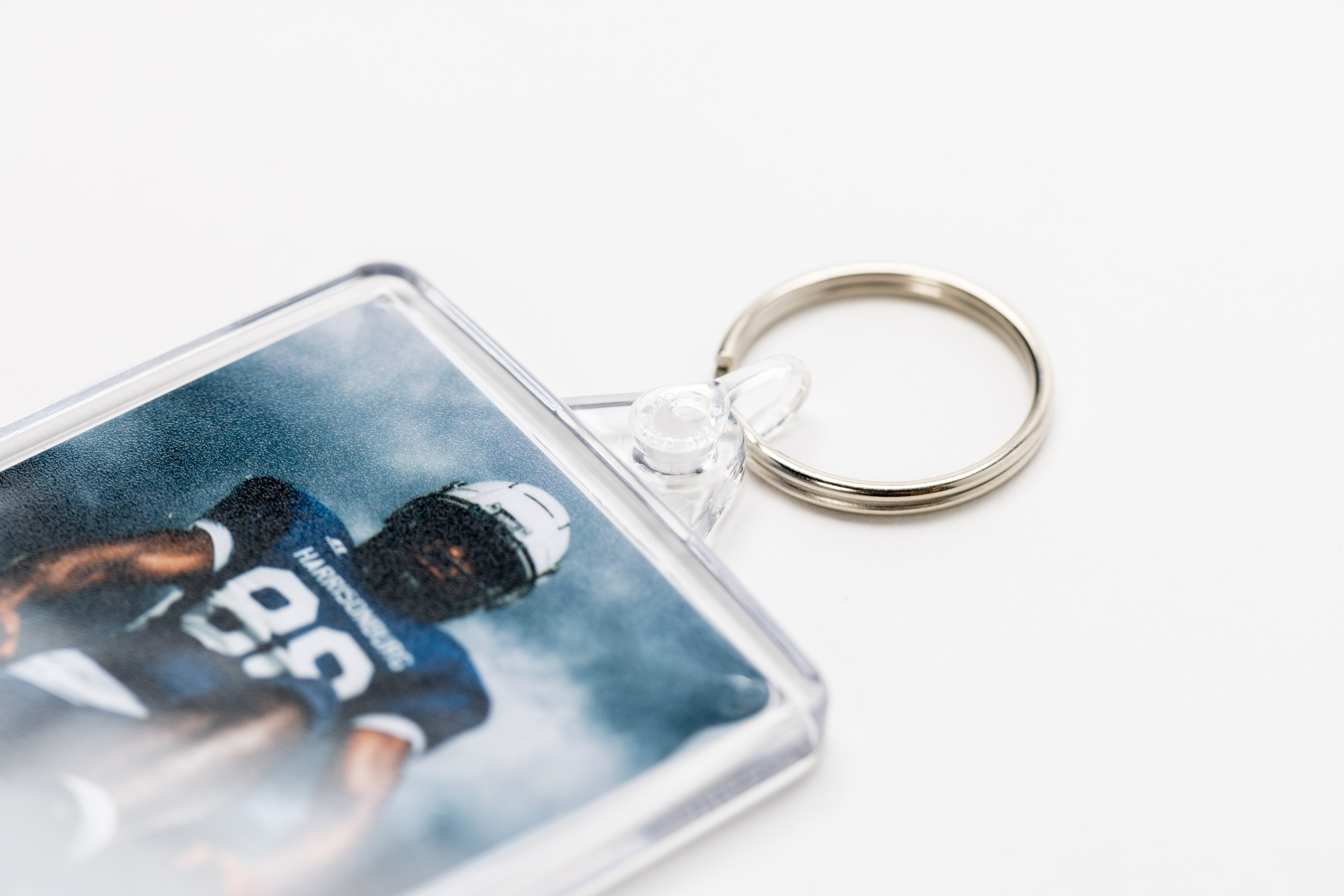 Close-up of hanging hardware for an Acrylic Keychain featuring football sports portrait