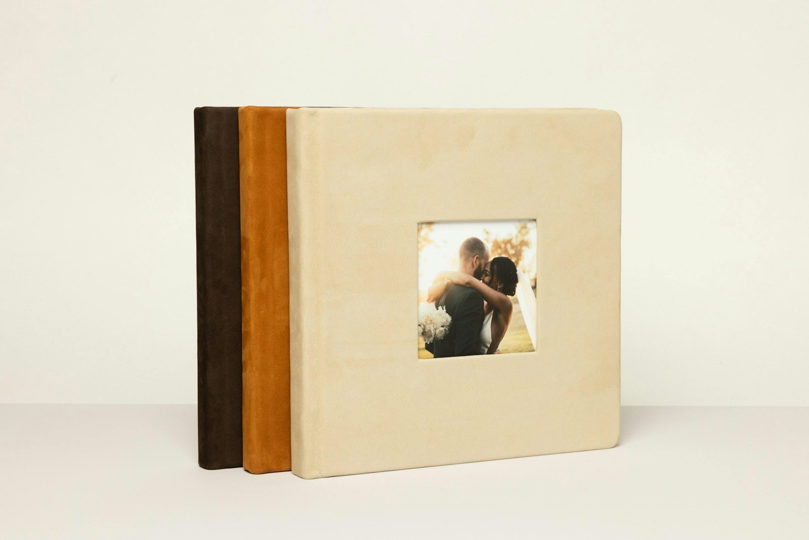 Three 10×10 Nubuck leather albums standing in a row