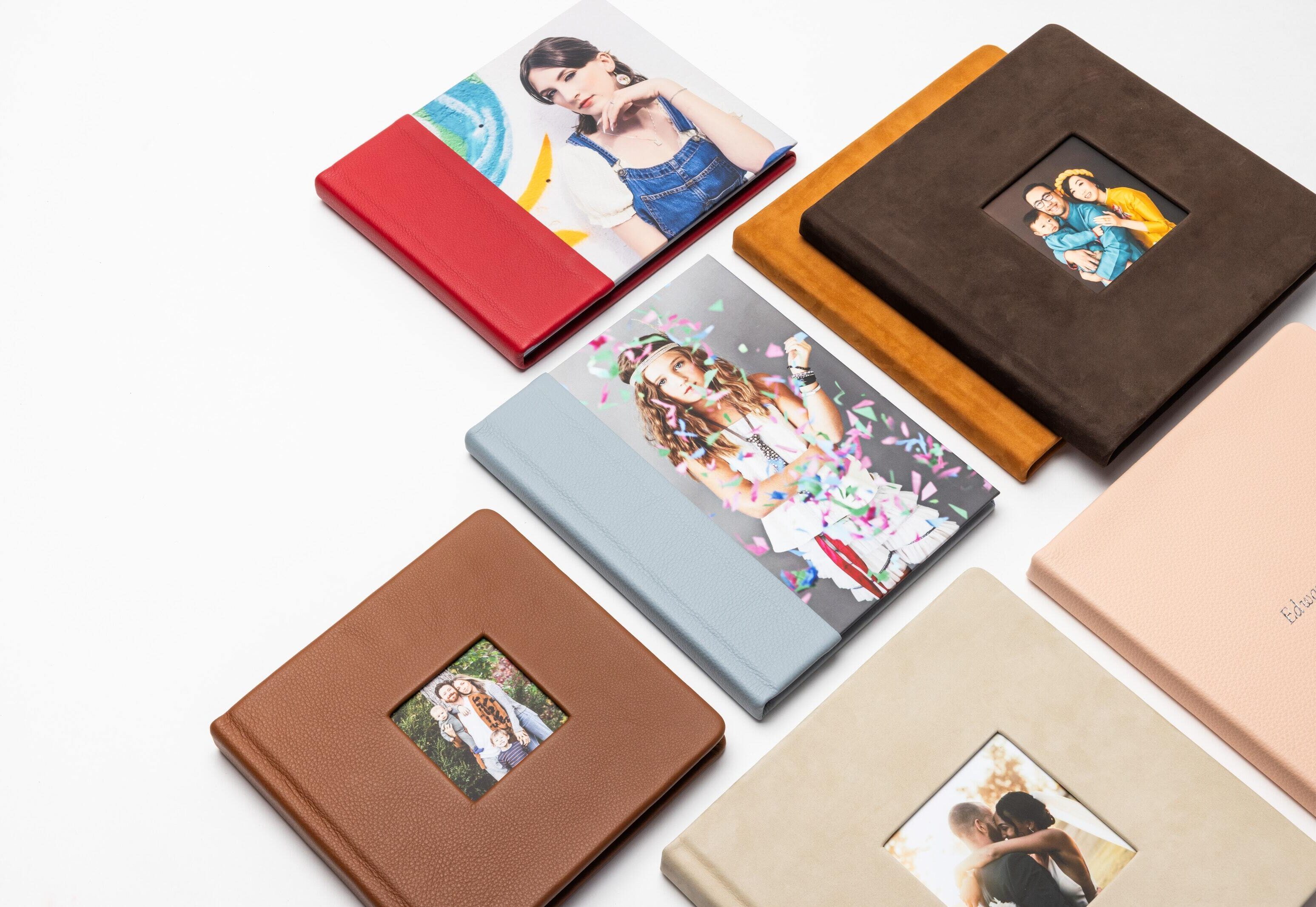 A collection of photo Albums and Books in a collage laying flat on a table.