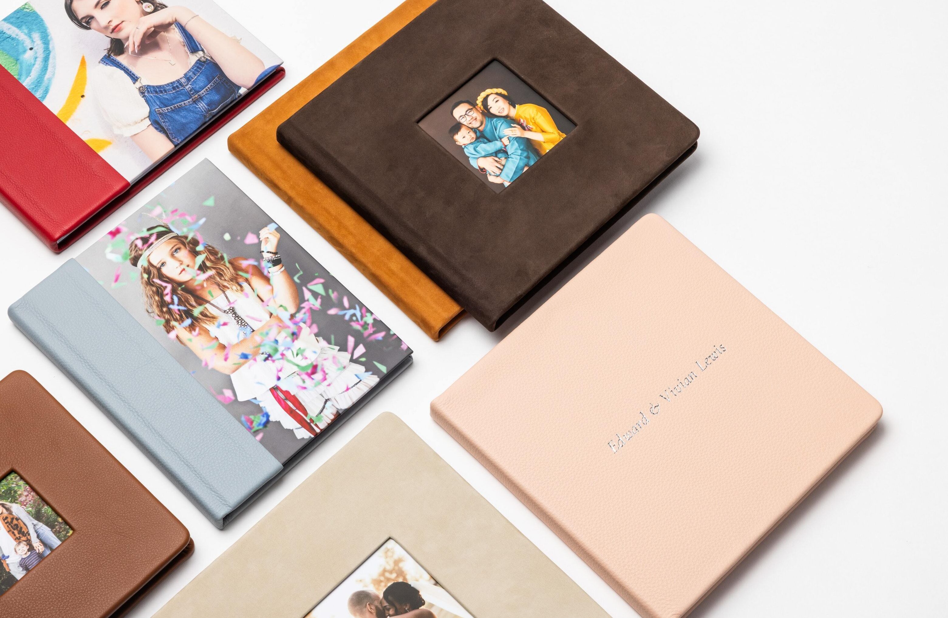 A collage of photo Albums and Layflat Books featuring new Premier and Nubuck leather options in various cover styles. Cameo, combo and full material cover options are featured, laying flat on a table.