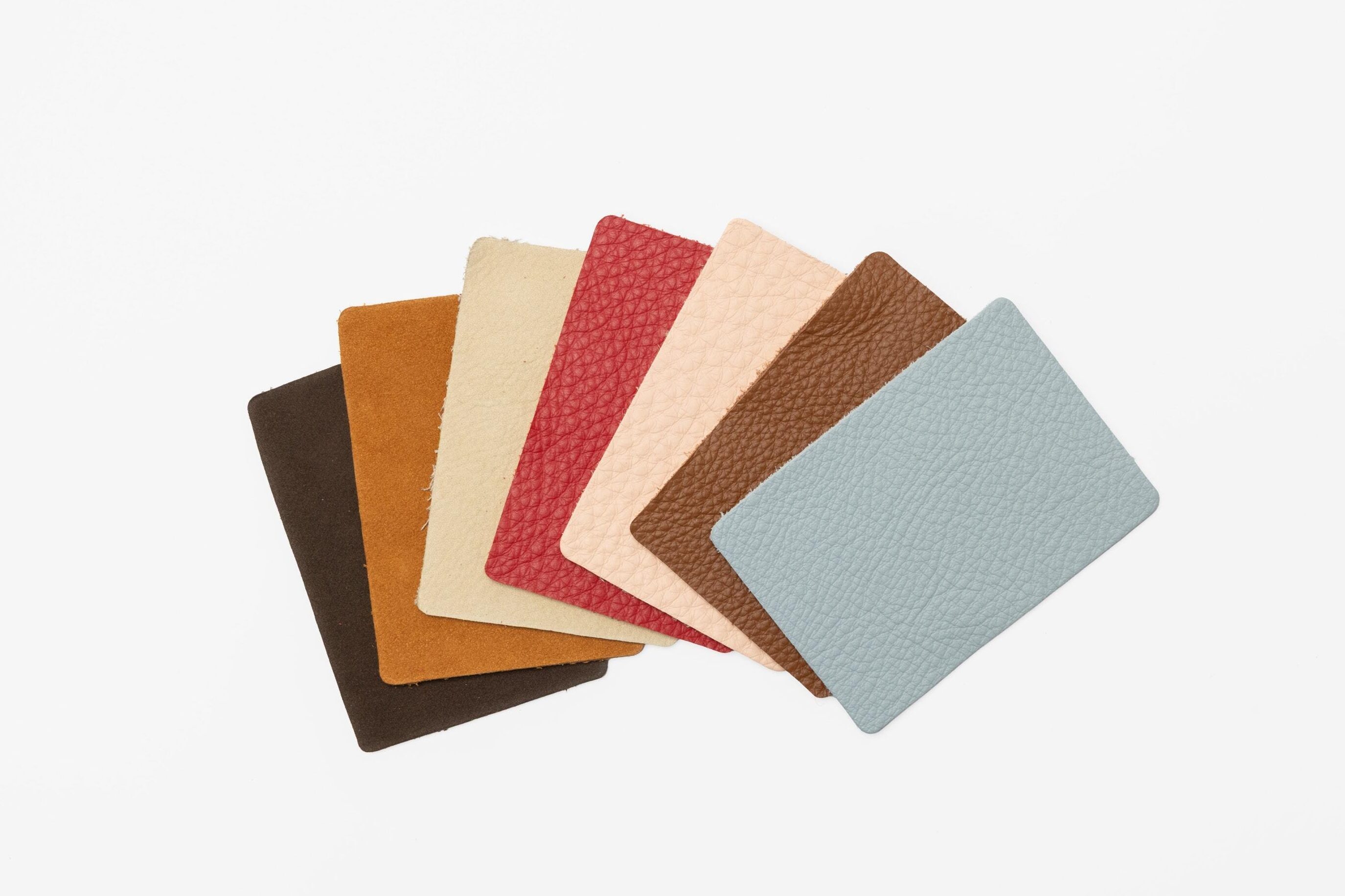 Leather swatches fanned out showcasing the new Premier Leather colors and the new Nubuck Leather line.
