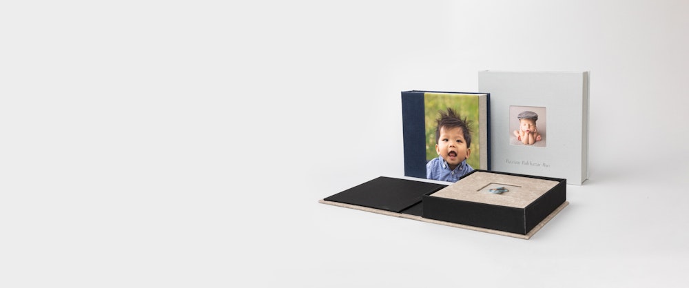 Multiple 3-panel Album Boxes with children portraits, one open flat with album inside