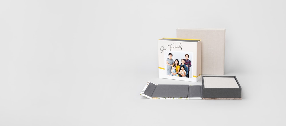Multiple 4-panel Album Boxes, one open flat with album inside