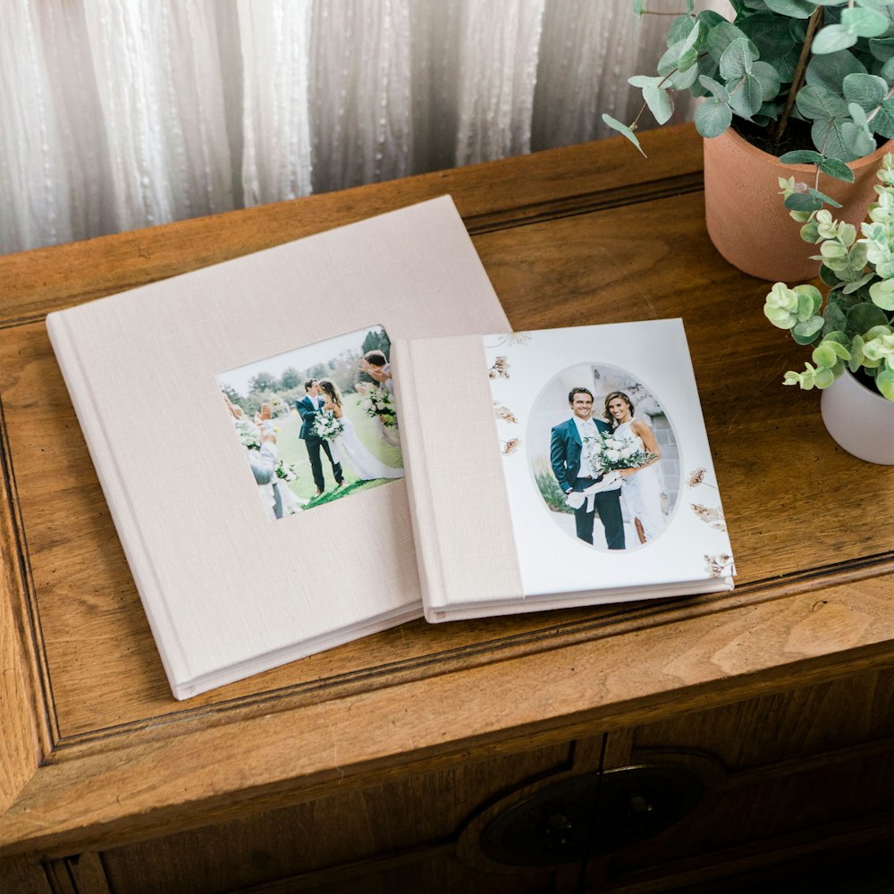 Companion Albums styled on table with blush linen combo & cameo covers