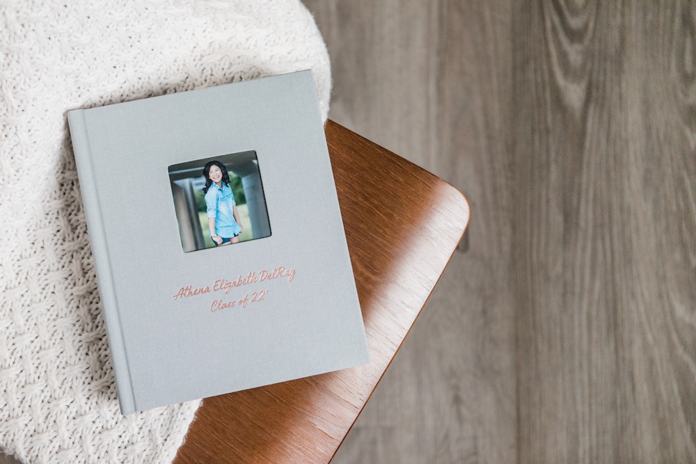 WHCC Albums high school senior fabric cameo cover rose gold foil debossing lifestyle on chair