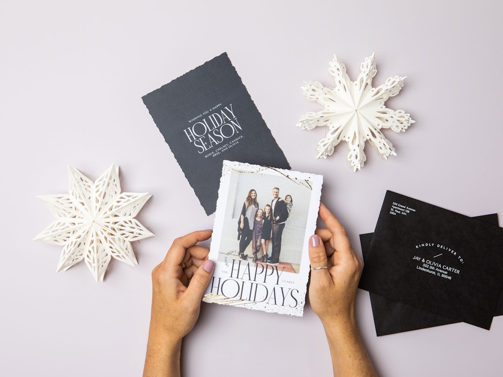 Editorial Holiday Cards Paper Snowflakes hands holding