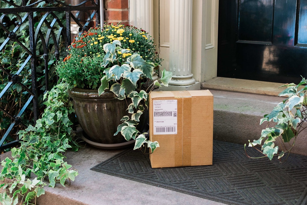 WHCC package delivered via Drop Shipping waiting on doorstep next to flower planter