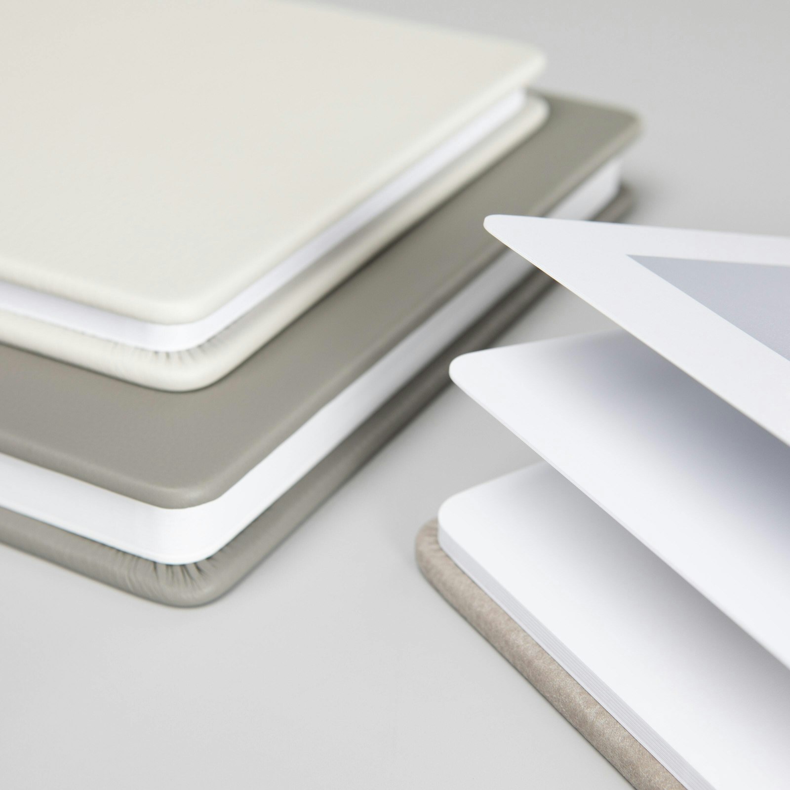 Stacked premium leather albums with rounded corners