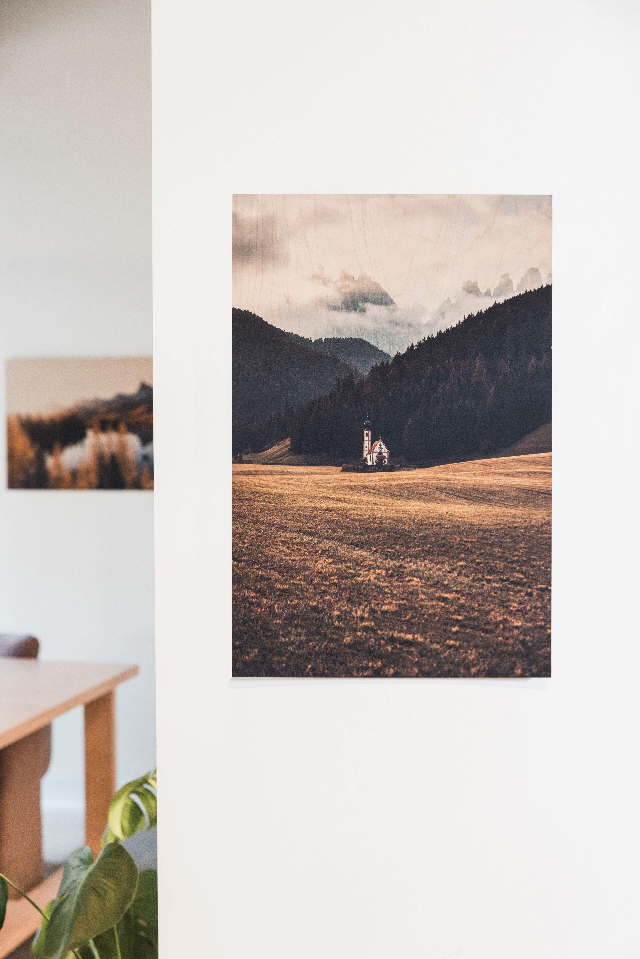 Landscape Wood Print of a golden mountain meadow displayed in a living space with a second print in the background