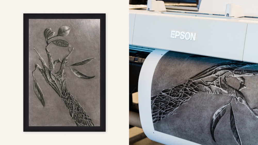 A black and white artwork depicting a hand with tree-like features and intricate root patterns. On the left, the art is framed, while on the right, the artwork is being printed by an Epson printer.