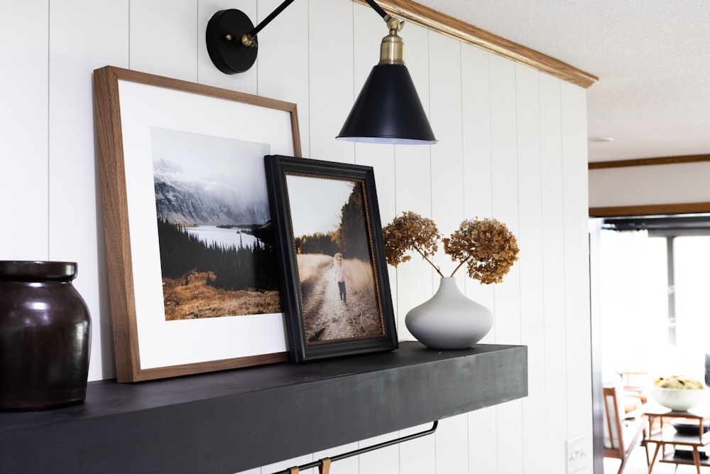 Woodland Walnut and Hudson Black and Gold Framed Prints leaning on kitchen shelf