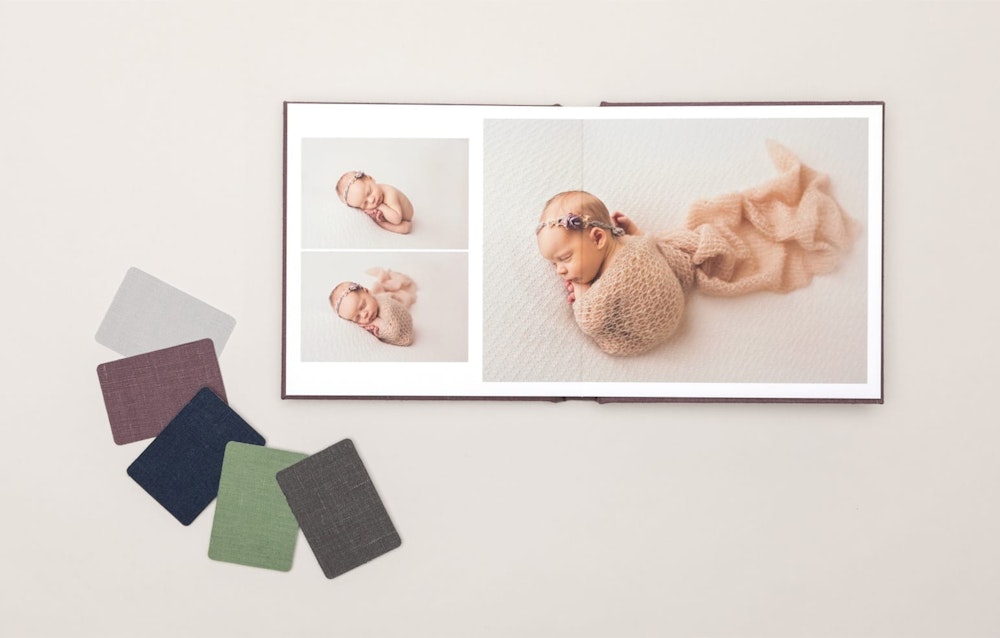 Open newborn Album spread with linen cover material swatches