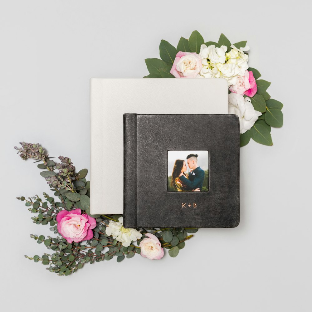 Coal distressed leather album styled with floral arrangement