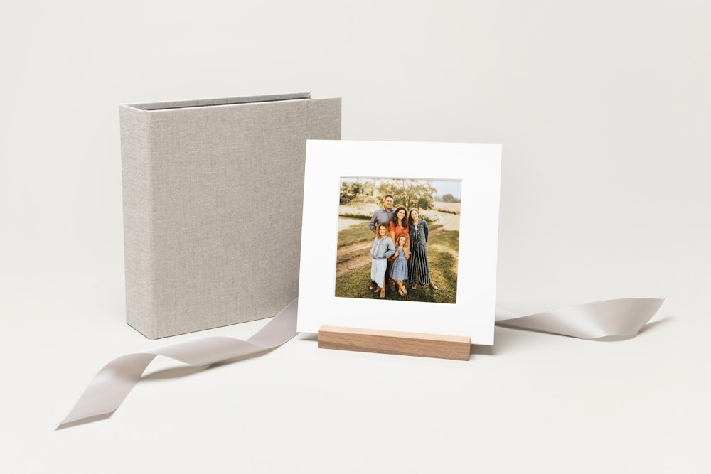 Square material cover Image Box with white matted print in wood display stand