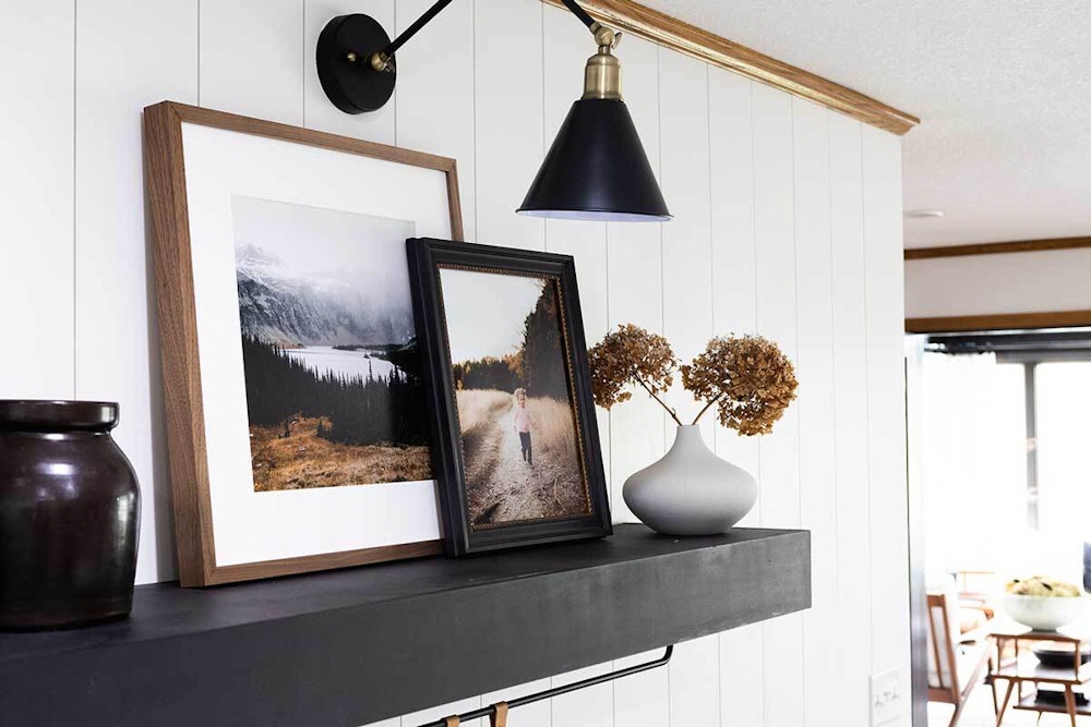 Woodland walnut Framed Print paired with hudson black and gold on kitchen shelf with light
